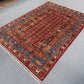 Pazyryk rug styled in living room setting with red and blue tones
