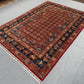 Side view of red and blue wool Pazyryk rug on floor