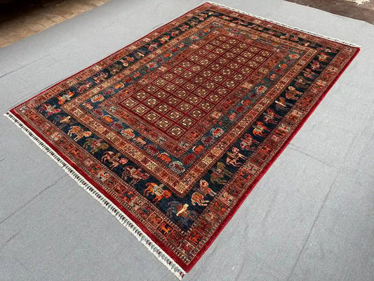 Side view of red and blue wool Pazyryk rug on floor