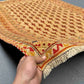 Handmade Persian Afghan rug held in hands showing tribal details