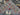 Folded edge of hand-knotted Persian hunting rug in wool, gray background