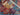 Folded edge and texture detail of colorful Persian-style patchwork rug