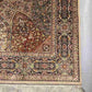 Corner detail showing floral and vine motifs on Persian rug