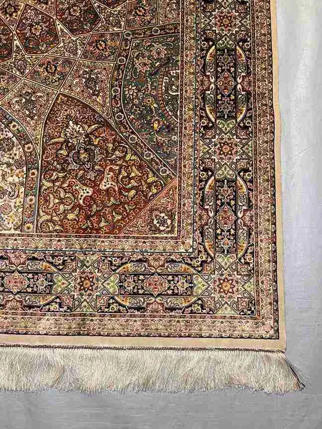 Corner detail showing floral and vine motifs on Persian rug