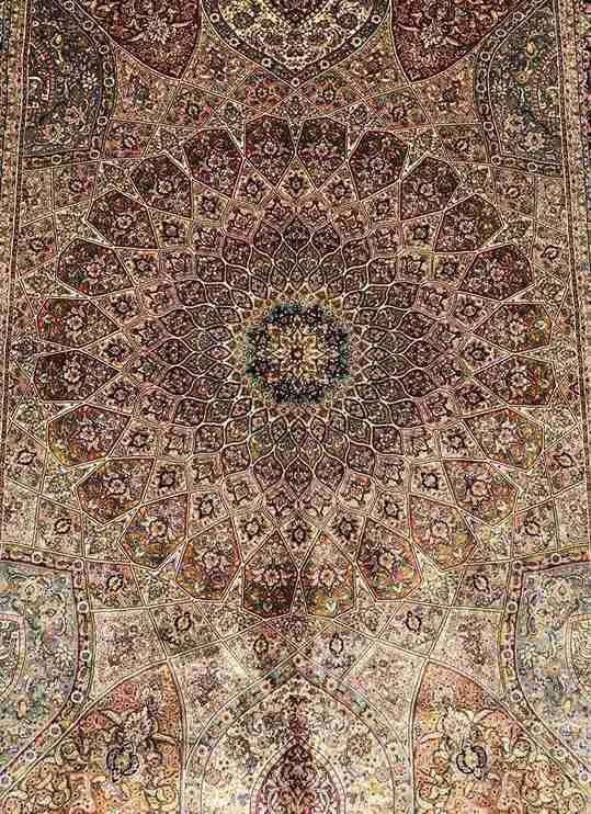 Hand-knotted floral detailing on Persian silk area rug