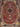 Close-up of burgundy medallion design on handmade Persian wool-silk rug