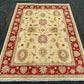 Persian-style handwoven red and cream rug placed on wood floor