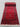 Persian-style hand-knotted red runner rug displayed in hallway decor setting