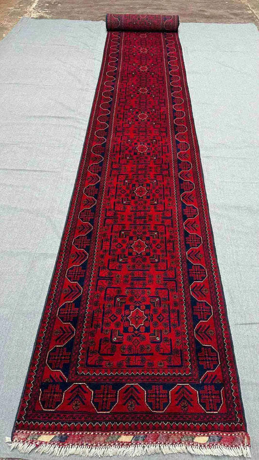 Red 3x23 runner rug placed in hallway setting