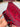 Hand-holding Red Afghan runner rug showing texture and weave