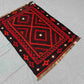 Styled floor display of red and black Kilim rug – Turkish handwoven wool area rug