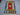 Persian-style Kilim in red and blue tones on hardwood floor