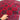 Handmade Red Kalisa wool rug held to show softness and texture