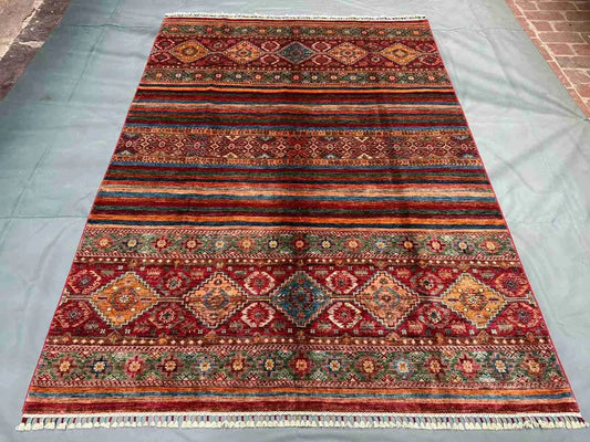 Red Khorjin rug on living room floor – Bohemian Persian area rug