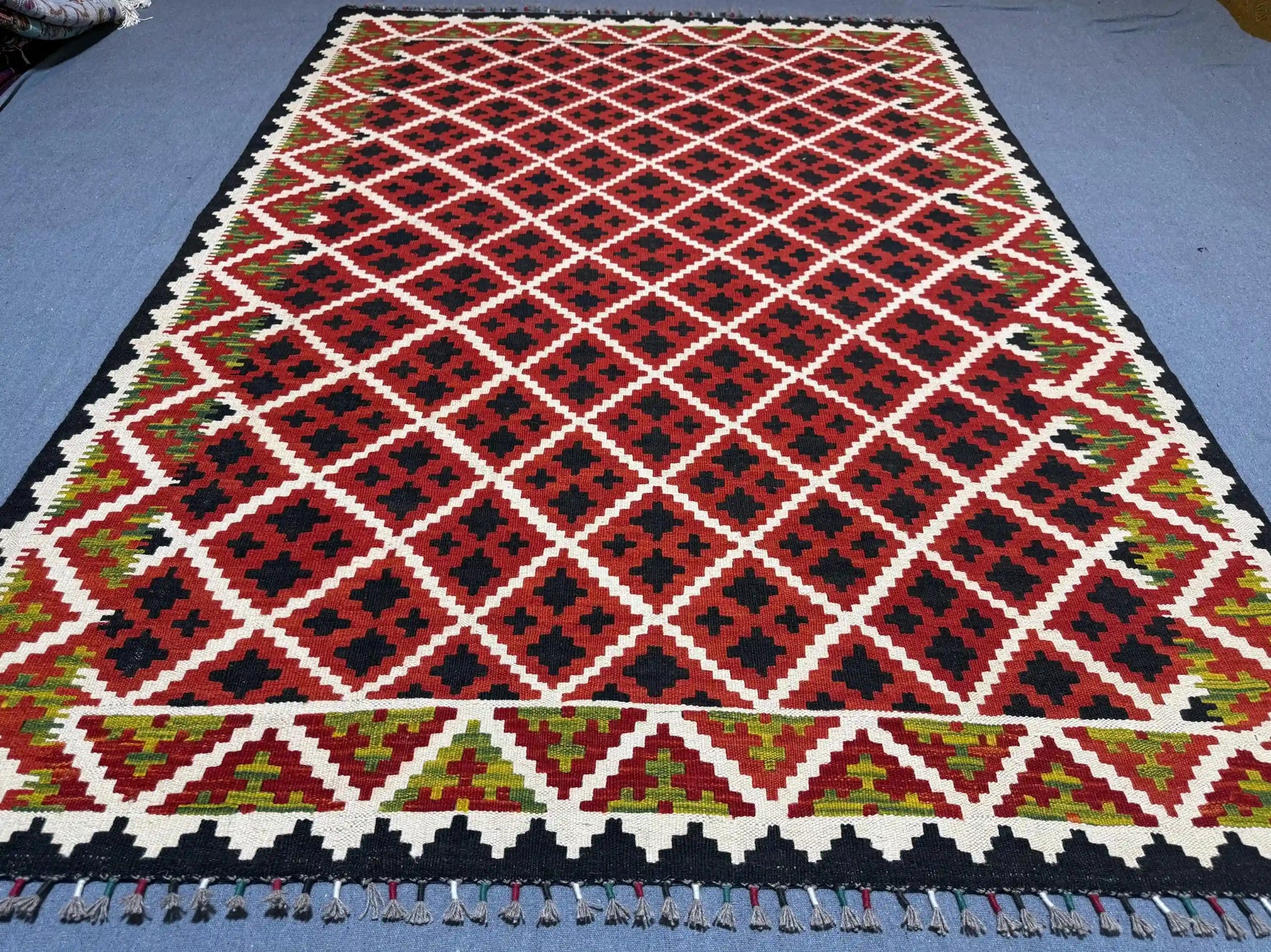 Red 5x7 kilim rug placed on floor in living room – tribal wool decor