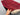 Handmade red Oriental wool rug held by artisan to show details