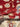 Handmade red Oriental wool rug in hands – front view