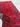 Folded red wool runner rug showing thickness and hand-knotted edges.