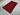 Handmade red Oriental rug styled on floor in compact living space