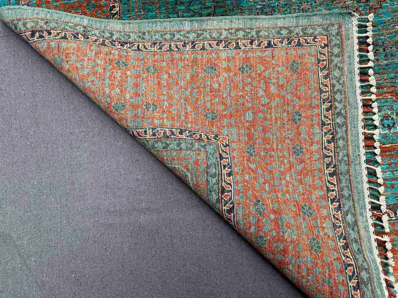 Backside and folded detail of 6x8 hand-knotted Mamluk wool rug