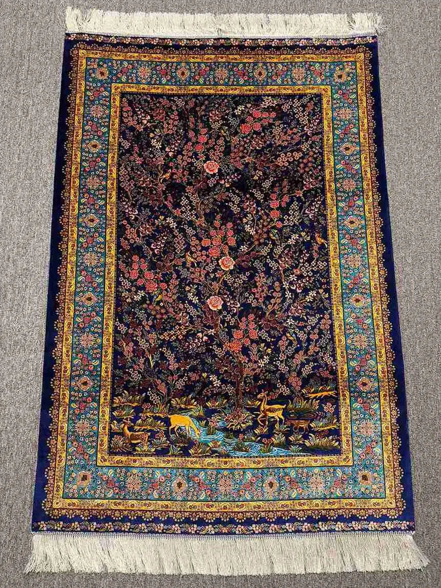 Persian silk rug with garden and deer motifs displayed in room