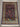 Persian silk rug with garden and deer motifs displayed in room