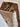 Side view of folded 2x3 silk wall tapestry rug with detailed patterns.