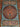 Close-up of blue and burgundy floral medallion pattern on Persian silk rug