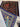 Hand-knotted edge detail of folded blue Persian silk wall rug