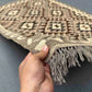 Handmade small Turkish Kilim rug held in hands – front view showing tribal wool flatweave pattern.