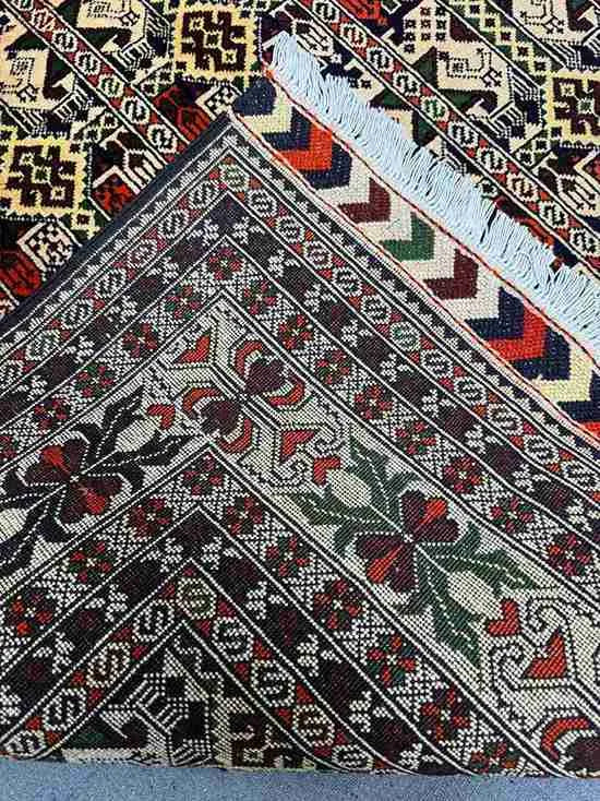 Folded view of handmade Oriental carpet showing soft wool silk texture