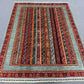 Floral and striped Turkish rug on floor in oriental living room