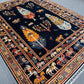 Dark blue Tree of Life rug styled in living room