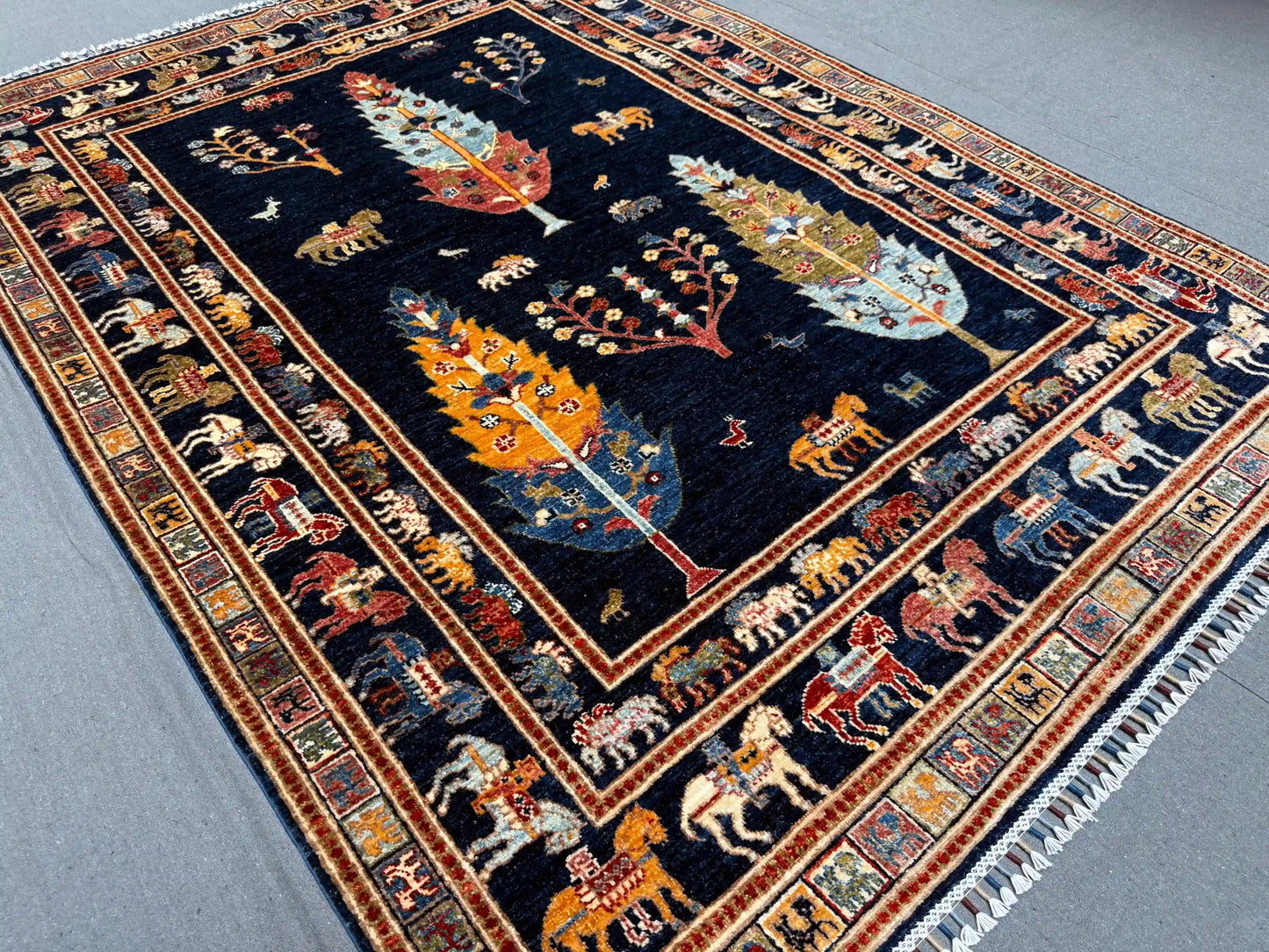 Dark blue Tree of Life rug styled in living room