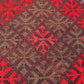 Texture close-up of red Afghan Kilim rug – handwoven geometric wool design.
