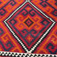 Close-up showing detailed wool texture of vintage Turkish Kilim rug – knotted and handmade.