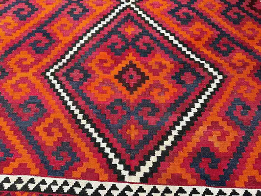 Close-up showing detailed wool texture of vintage Turkish Kilim rug – knotted and handmade.