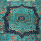 Close-up texture of hand-knotted wool Mamluk rug in green and gold
