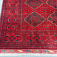 Wool texture detail of red Afghan-inspired handmade rug