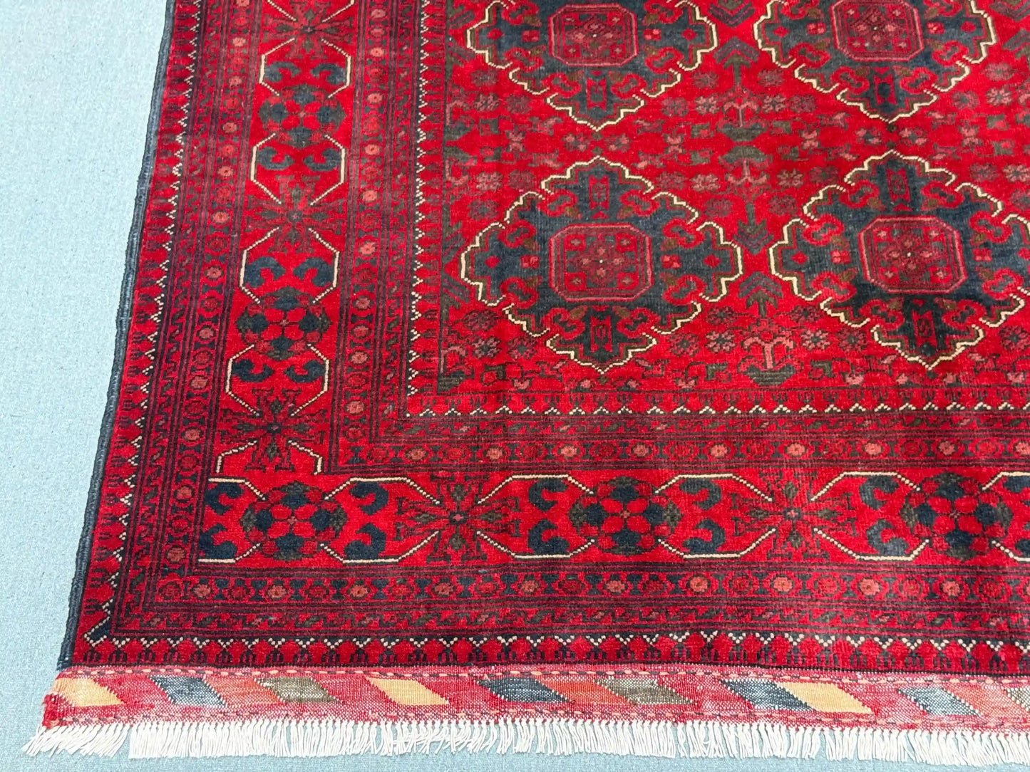 Wool texture detail of red Afghan-inspired handmade rug