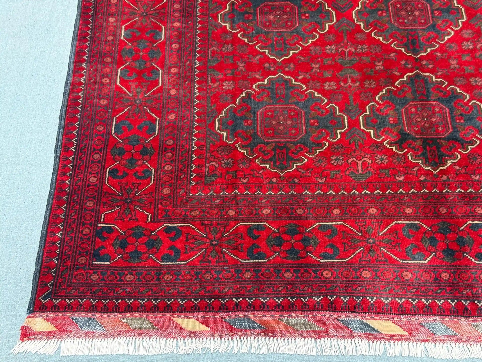 Wool texture detail of red Afghan-inspired handmade rug
