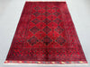 Top-down full view of Afghan tribal wool rug