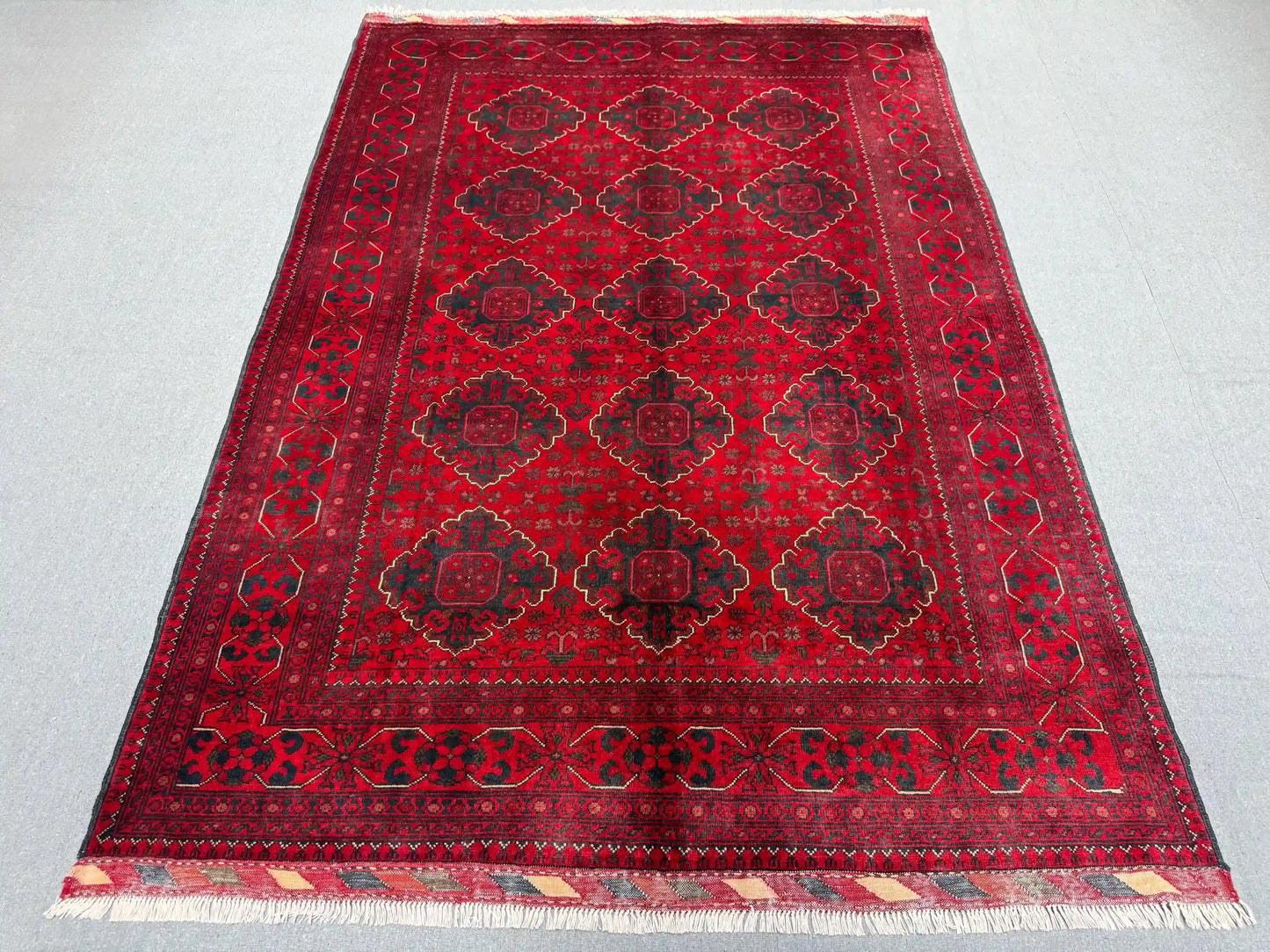 Top-down full view of Afghan tribal wool rug