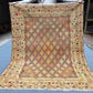Full top-down view of handwoven 5x6.2 Afghan Turkish rug with beige, gold & brown tribal geometric design