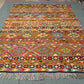 Floor scene with traditional handwoven Khorjin Kilim rug – bold colors and Persian-style flatweave.