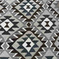 Close-up texture of traditional Turkish Kilim pattern – knotted wool rug in warm earth tones.