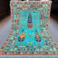 Full view of Tree of Life wool carpet in turquoise blue on floor