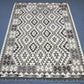 Floor view of tribal patterned wool Kilim rug in monochrome colors