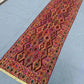 Side angle of vintage wool kilim rug placed in entryway