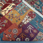 Folded tribal patchwork rug with visible texture and stitching detail
